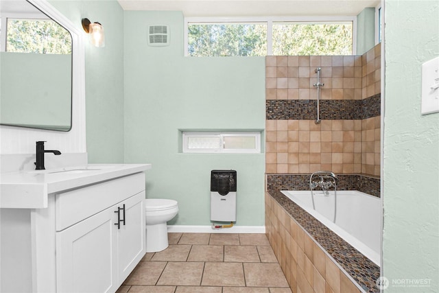 bathroom featuring tile patterned flooring, toilet, visible vents, vanity, and heating unit