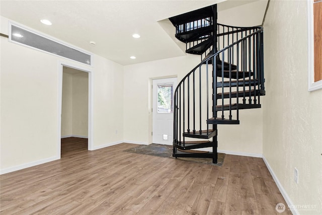 interior space featuring recessed lighting, wood finished floors, and baseboards