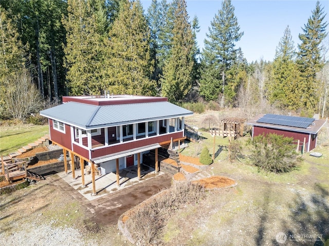 birds eye view of property featuring a view of trees