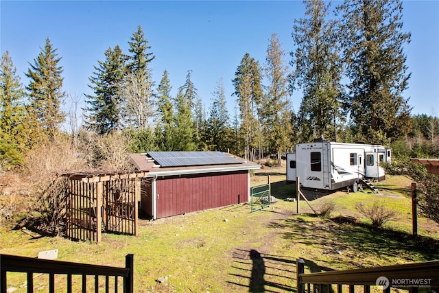 view of yard with an outbuilding, an outdoor structure, and fence