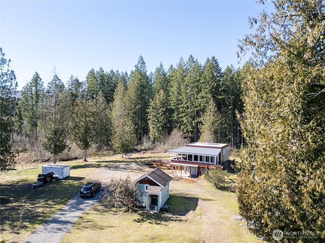 drone / aerial view with a wooded view