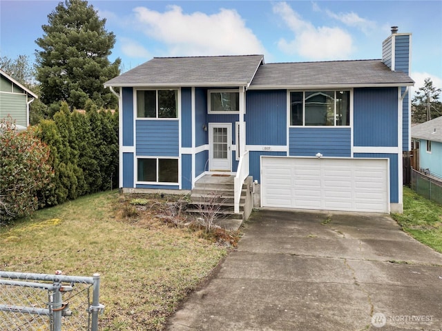 split foyer home with a front lawn, driveway, fence, a garage, and a chimney