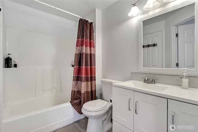 full bath with vanity, shower / tub combo, toilet, and backsplash