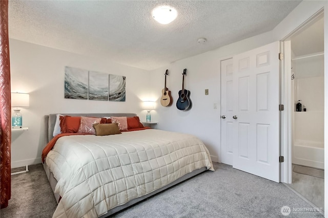 bedroom featuring baseboards, carpet, and a textured ceiling