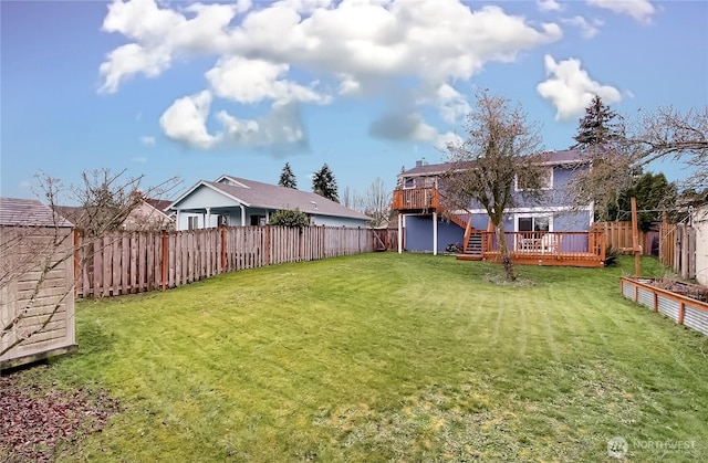 view of yard with a deck and a fenced backyard