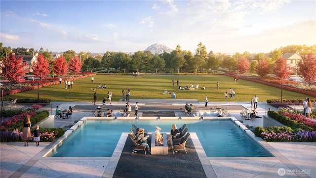 view of swimming pool with an infinity pool, a mountain view, a lawn, and a patio