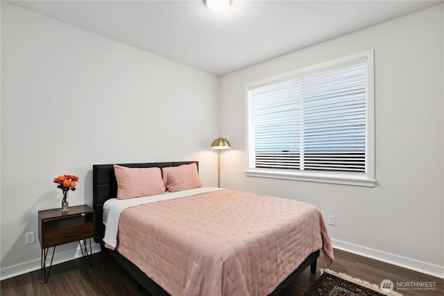 bedroom with baseboards and wood finished floors