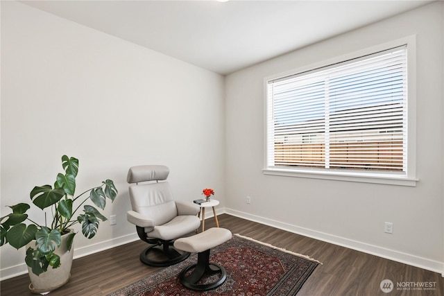 sitting room with wood finished floors and baseboards