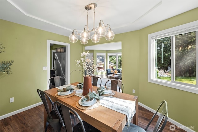 dining space featuring dark wood-style flooring and baseboards