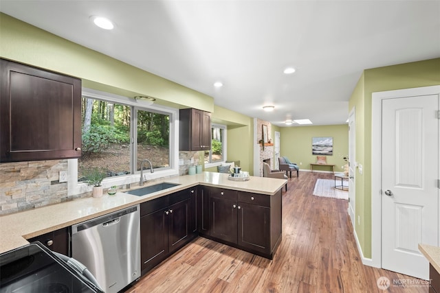 kitchen with a sink, light countertops, stainless steel dishwasher, dark brown cabinets, and decorative backsplash