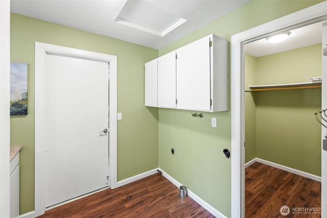 laundry area with dark wood-style floors, cabinet space, attic access, electric dryer hookup, and baseboards