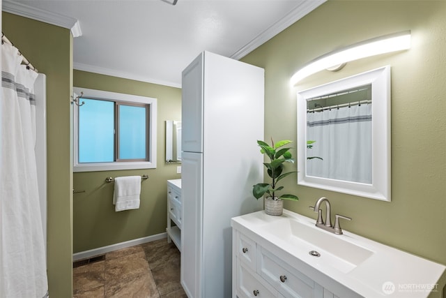 full bathroom featuring crown molding, vanity, and baseboards