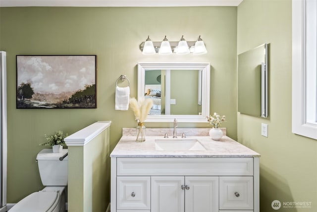 bathroom featuring vanity and toilet