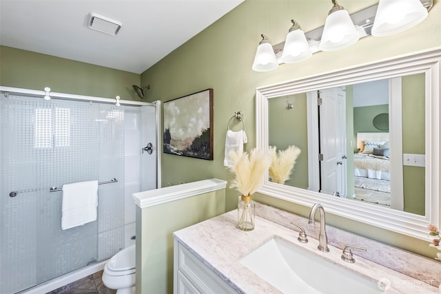 full bath with connected bathroom, toilet, a shower stall, and vanity