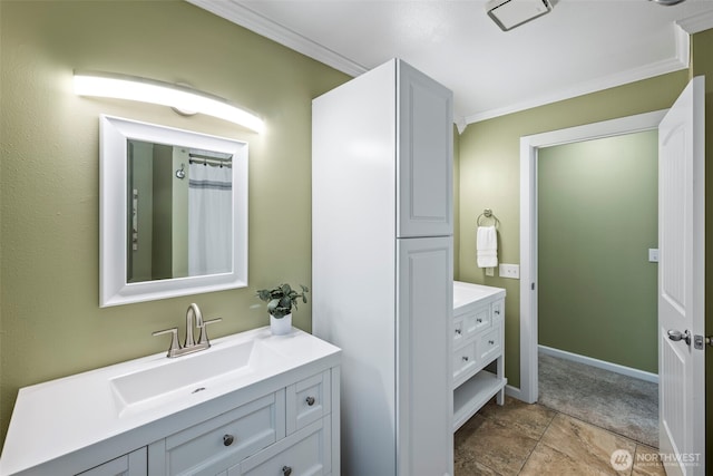 full bath with baseboards, crown molding, and vanity