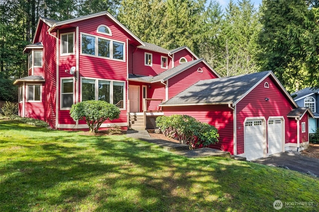 view of front of property with aphalt driveway, a garage, and a front lawn