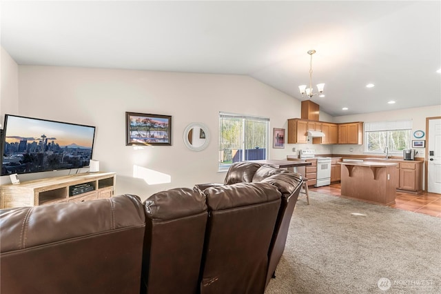 living room with recessed lighting, light colored carpet, an inviting chandelier, and vaulted ceiling