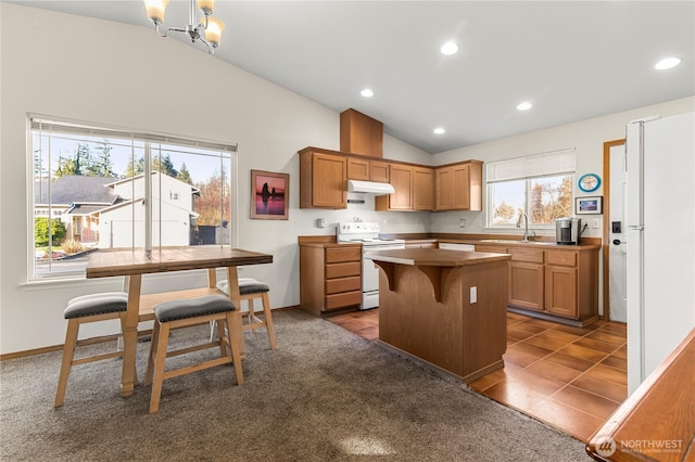 kitchen featuring white range with electric stovetop, a sink, vaulted ceiling, under cabinet range hood, and a center island