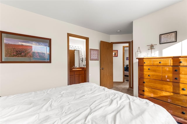 bedroom featuring carpet flooring, connected bathroom, and a sink