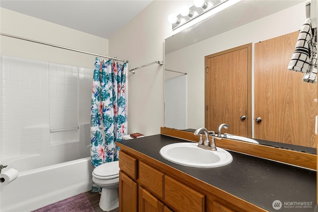 bathroom with shower / bath combo with shower curtain, toilet, and vanity