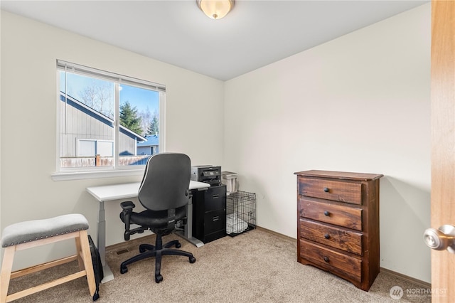 carpeted office featuring baseboards