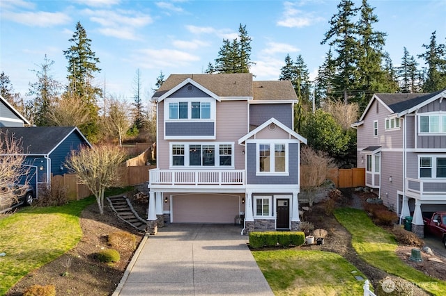 view of front of property featuring a shingled roof, concrete driveway, an attached garage, fence, and stone siding