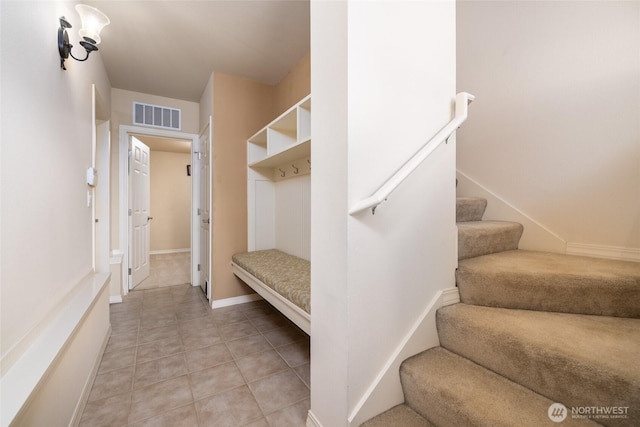 mudroom with light tile patterned floors, baseboards, and visible vents