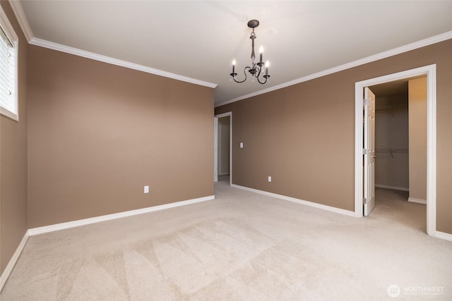 empty room with light carpet, crown molding, and baseboards