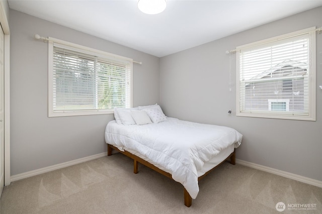 carpeted bedroom with baseboards