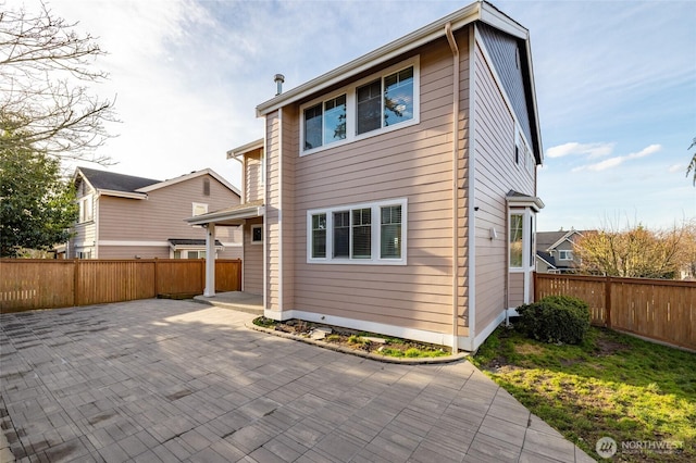 back of property featuring a patio area and a fenced backyard