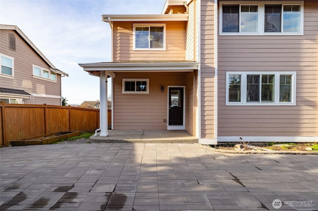 back of house with fence and a patio