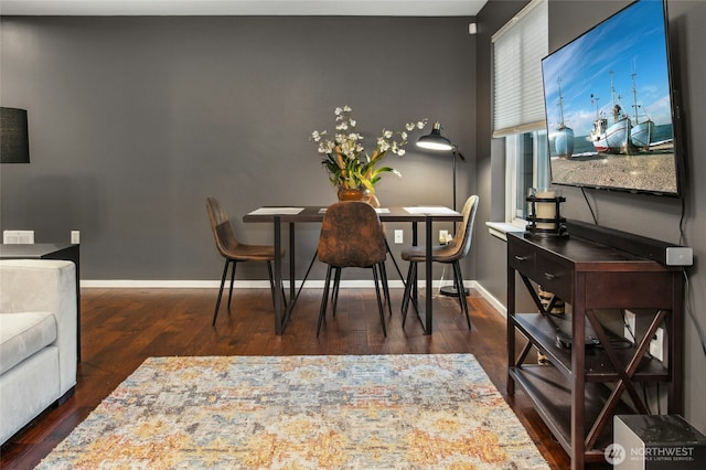 dining room with baseboards and wood finished floors