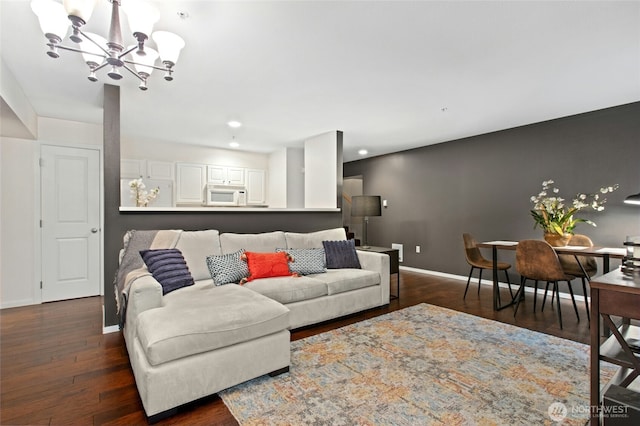 living room with baseboards, a chandelier, dark wood-style flooring, and recessed lighting