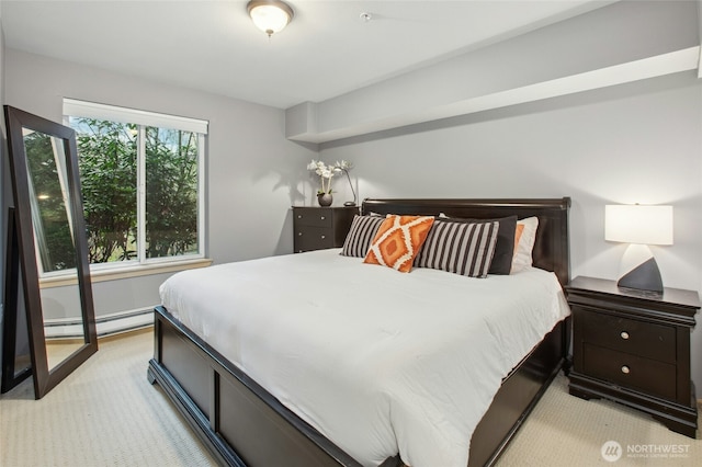 bedroom featuring a baseboard heating unit and light colored carpet