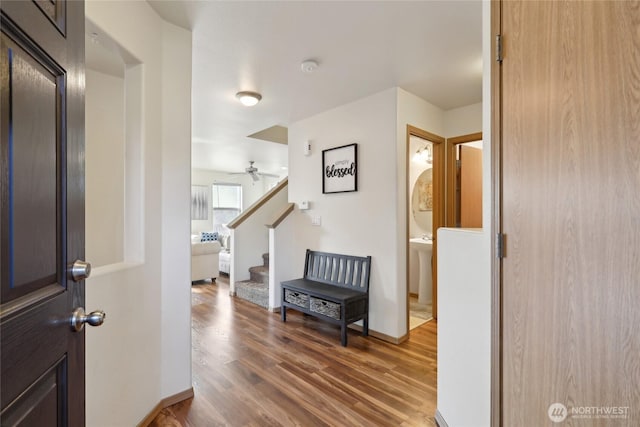 foyer featuring stairway, baseboards, and wood finished floors