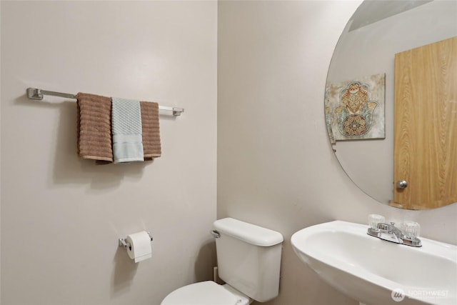 bathroom with toilet and a sink