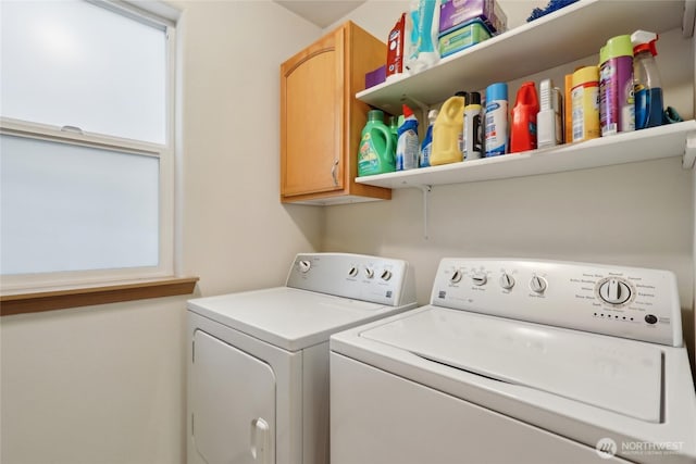 washroom with washing machine and clothes dryer, cabinet space, and a healthy amount of sunlight