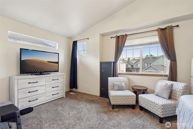 sitting room with vaulted ceiling and carpet flooring