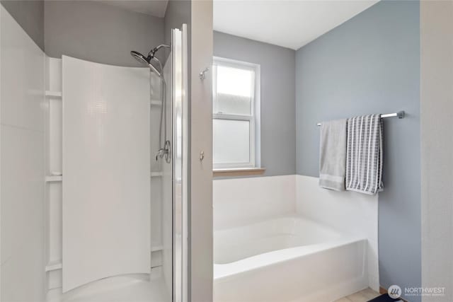 bathroom with a garden tub and a shower stall