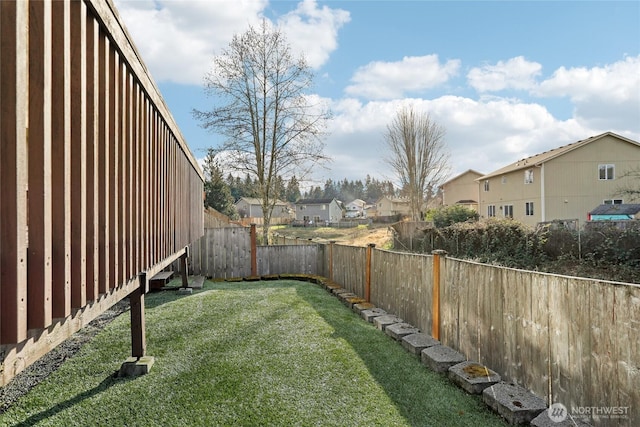 view of yard with a residential view and a fenced backyard