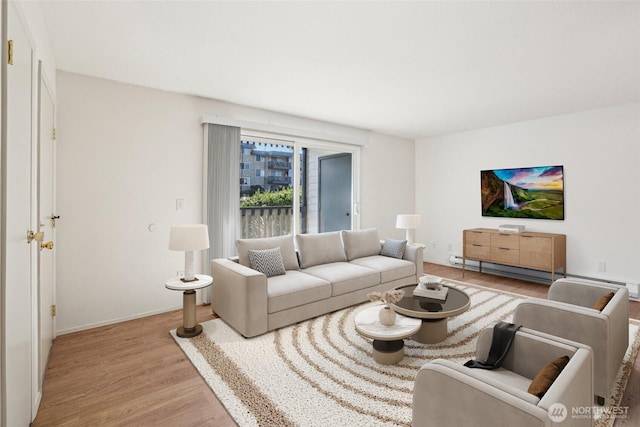 living area with light wood-style floors, baseboard heating, and baseboards