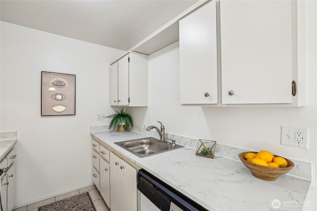 kitchen featuring light tile patterned floors, white dishwasher, white cabinets, and a sink