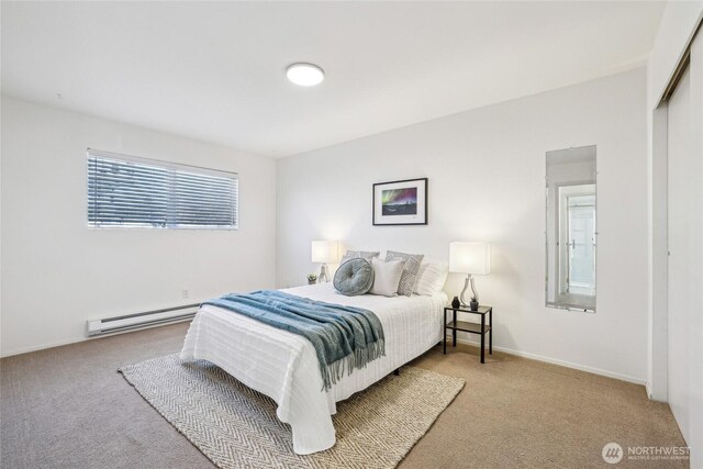 carpeted bedroom featuring a baseboard radiator and baseboards