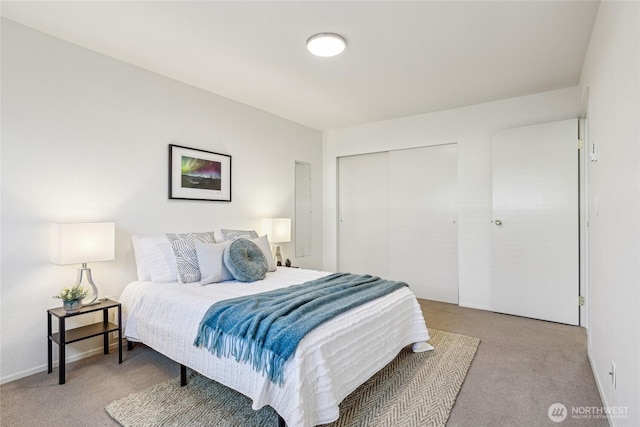 bedroom featuring a closet, carpet flooring, and baseboards