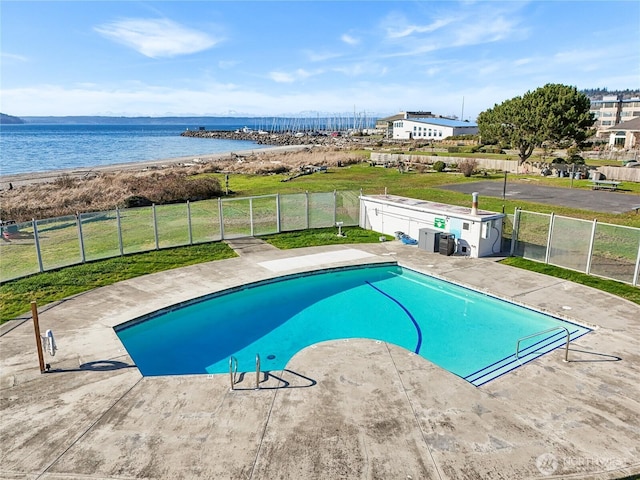 view of pool featuring a fenced in pool, a yard, a water view, a patio area, and fence