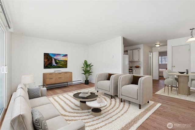 living room with a baseboard radiator and light wood-style floors