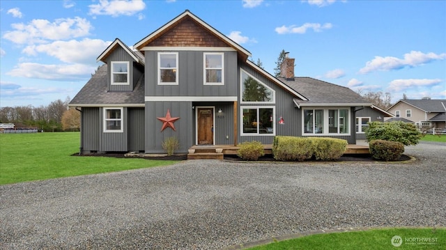 view of front of property featuring a front lawn, crawl space, and a shingled roof