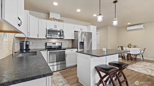 kitchen featuring stainless steel appliances, a wall mounted air conditioner, dark wood-type flooring, and a kitchen breakfast bar