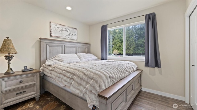 bedroom featuring baseboards, dark wood-type flooring, and recessed lighting