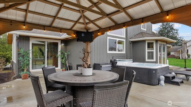 view of patio / terrace with a gazebo, outdoor dining space, and a hot tub